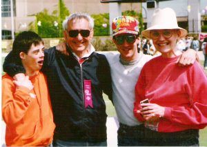 Billy, Paul, and their parents at a Special Olympics event that Billy competed in.