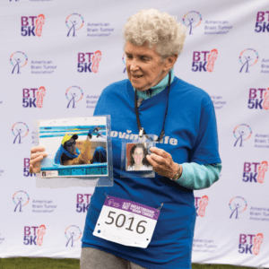 Sally Walker with photos of her late daughter Kristi at the Chicago BT5K in 2023