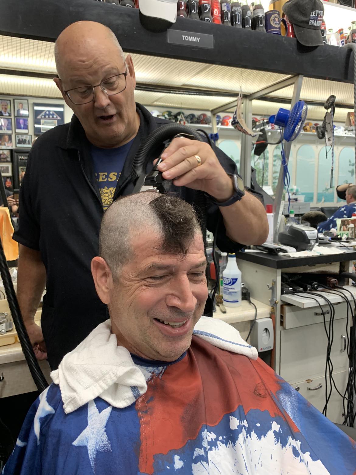 Neill Ferrill at the barber getting his head shaved